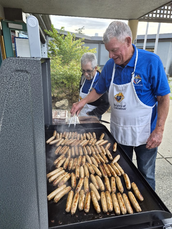 Grilling sausages for the pancake breakfast