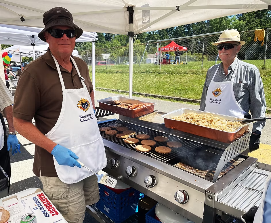 Cooking burgers and hot dogs for the community