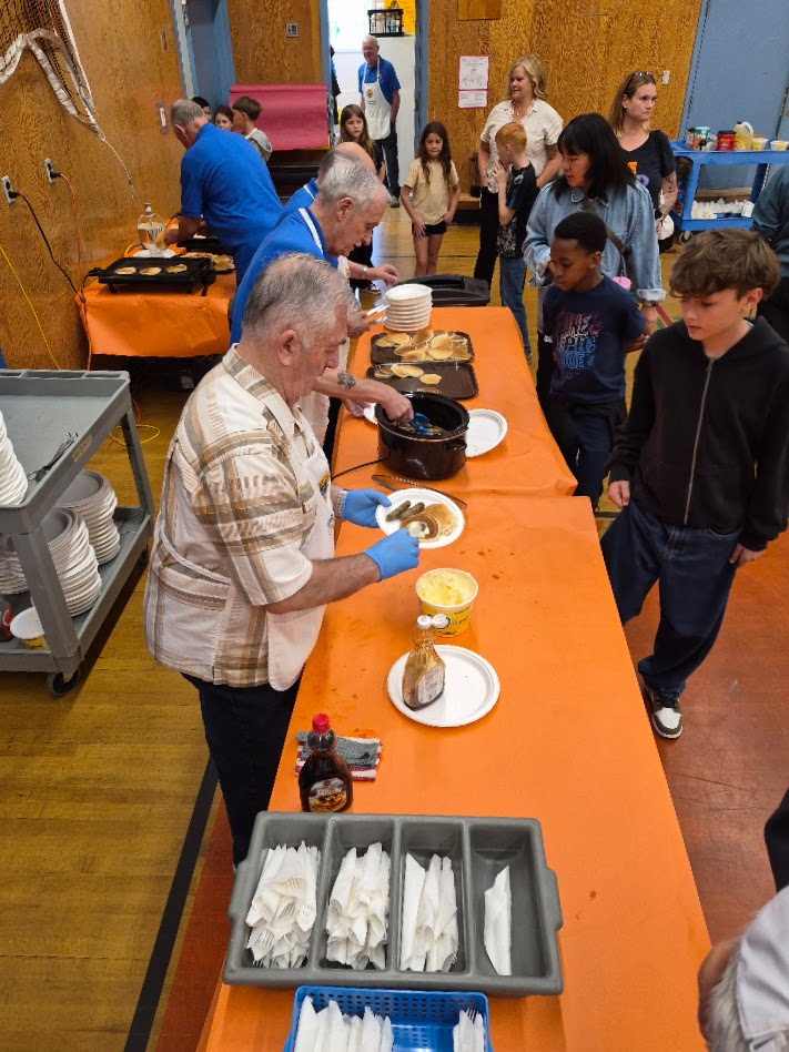 Students moving through the pancake serving line